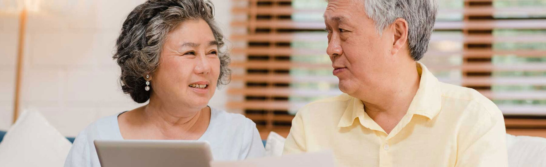 Australian Digital Inclusion Alliance - older asian couple smiling with a laptop
